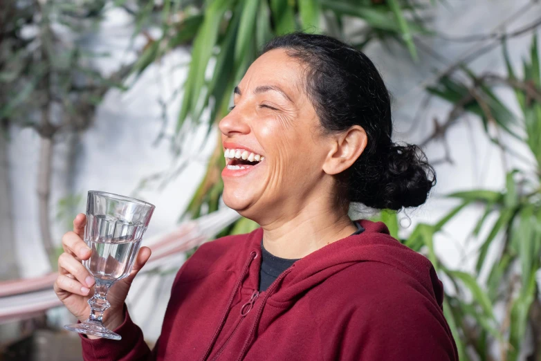 a woman laughing and holding a glass of water, pexels contest winner, renaissance, hito steyerl, manuka, profile image, ana de la reguera portrait