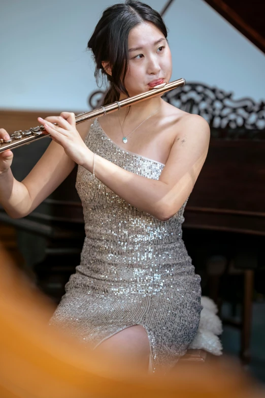 a woman in a silver dress playing a flute, steve zheng, thumbnail, wearing an elegant dress, petite