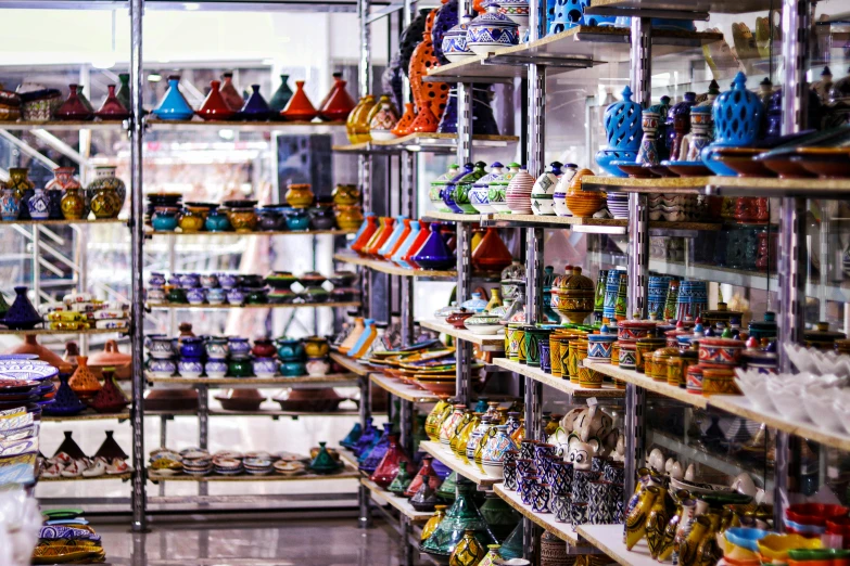 a store filled with lots of different types of vases, a tilt shift photo, unsplash, cloisonnism, futuristic marrakech, 🦩🪐🐞👩🏻🦳, shelves filled with tomes, colorful robes