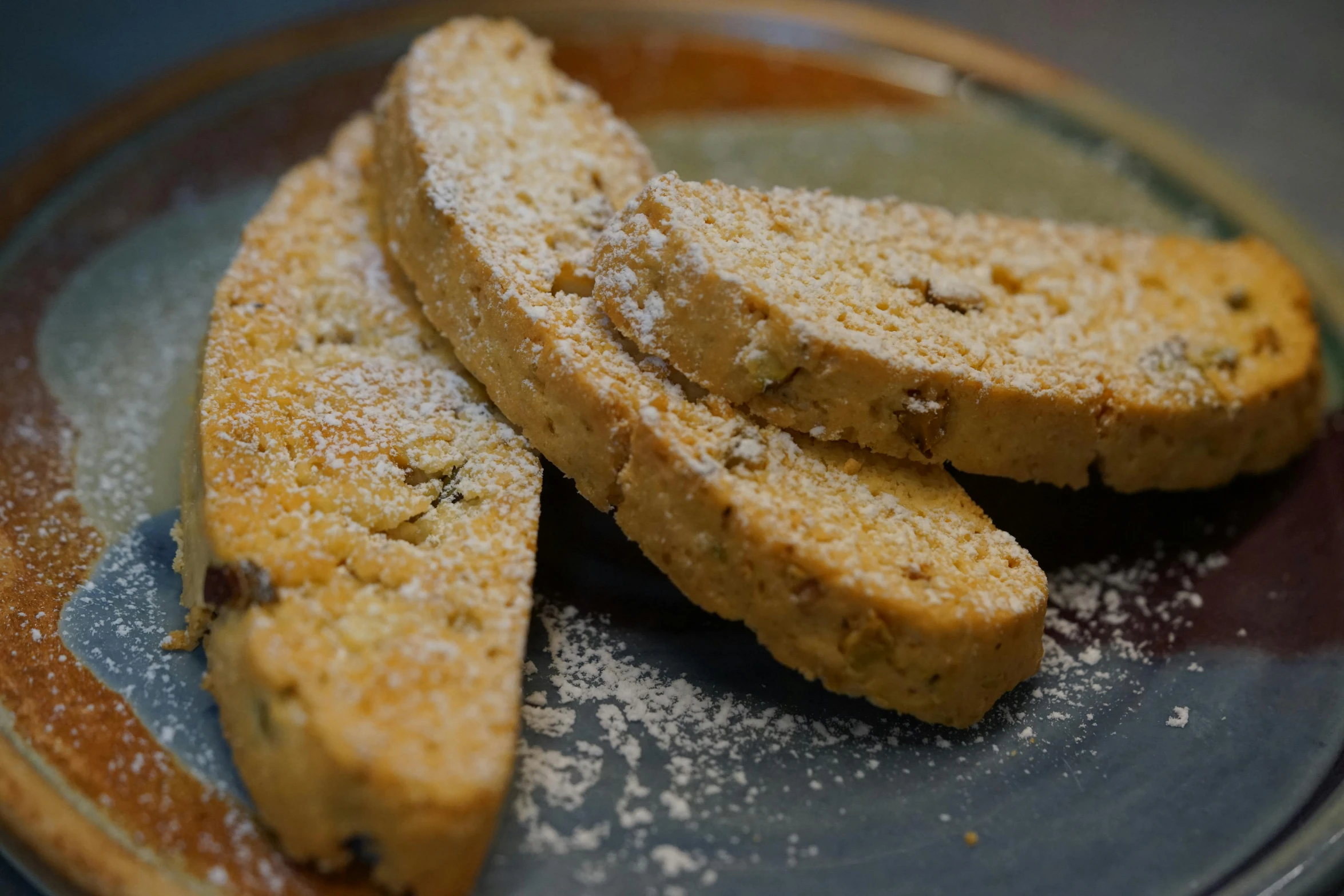 three pieces of bread on a plate with powdered sugar, a portrait, by Carey Morris, pexels, renaissance, cookies, 3/4 side view, constantine, panorama