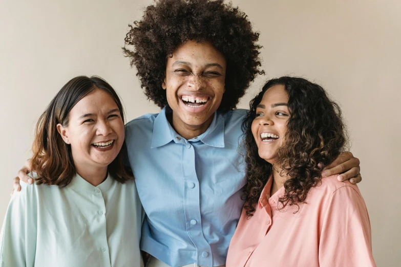 a group of three women standing next to each other, trending on pexels, happening, very huge smile, avatar image, light-brown skin, playful smile