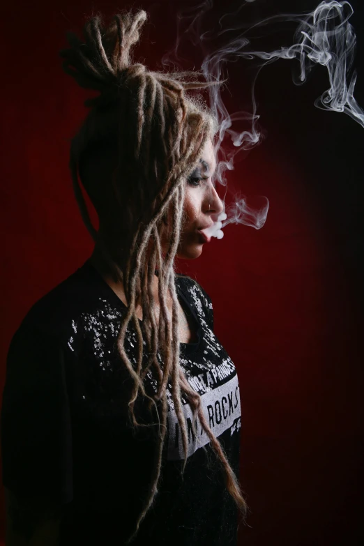 a woman with dreadlocks smoking a cigarette, a portrait, inspired by Elsa Bleda, unsplash, trippie redd, a blond, waist - up, studio photo