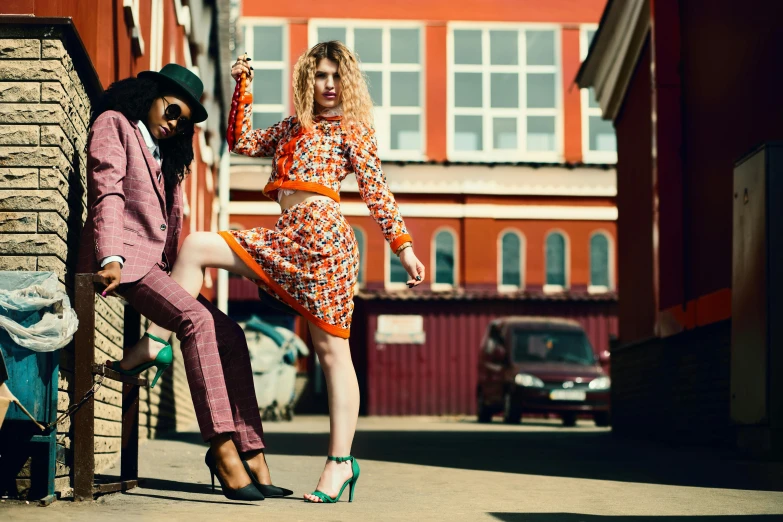 a man and a woman standing next to each other, by Lee Loughridge, pexels contest winner, colorful fashion, square, retro style ”, street pic