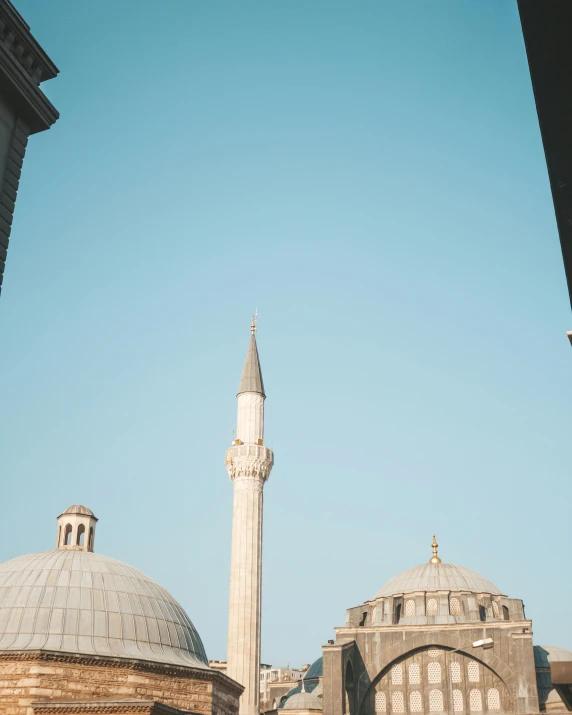 a group of people standing in front of a building, inspired by Osman Hamdi Bey, pexels contest winner, neoclassicism, minarets, dome, from the roof, view from the distance