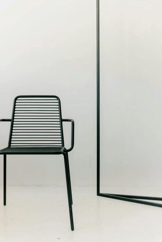 a black chair sitting in front of a mirror, by Francesco Furini, conceptual art, green lines, al fresco, gradient green black, made of wire