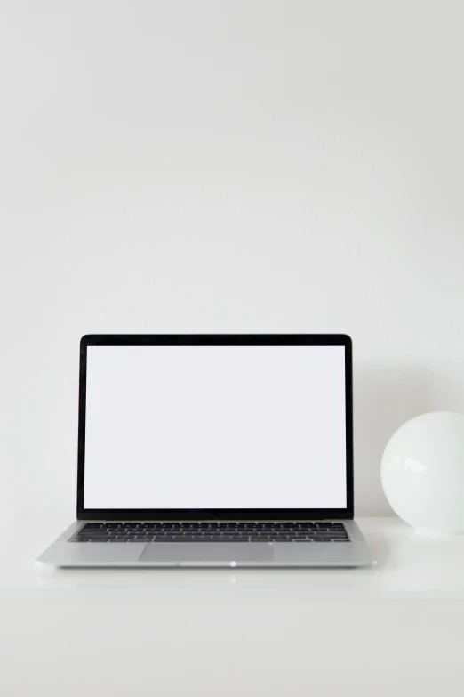 a laptop computer sitting on top of a white desk, pexels, white backdrop, 💣 💥💣 💥, minimalist lighting, my computer icon