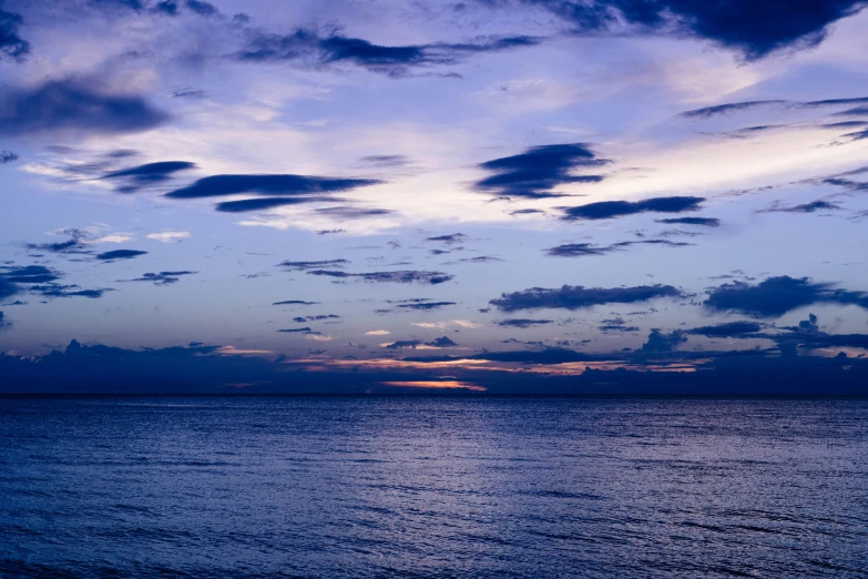 a large body of water under a cloudy sky, an album cover, unsplash, romanticism, blue and violet, predawn, seaview, instagram post