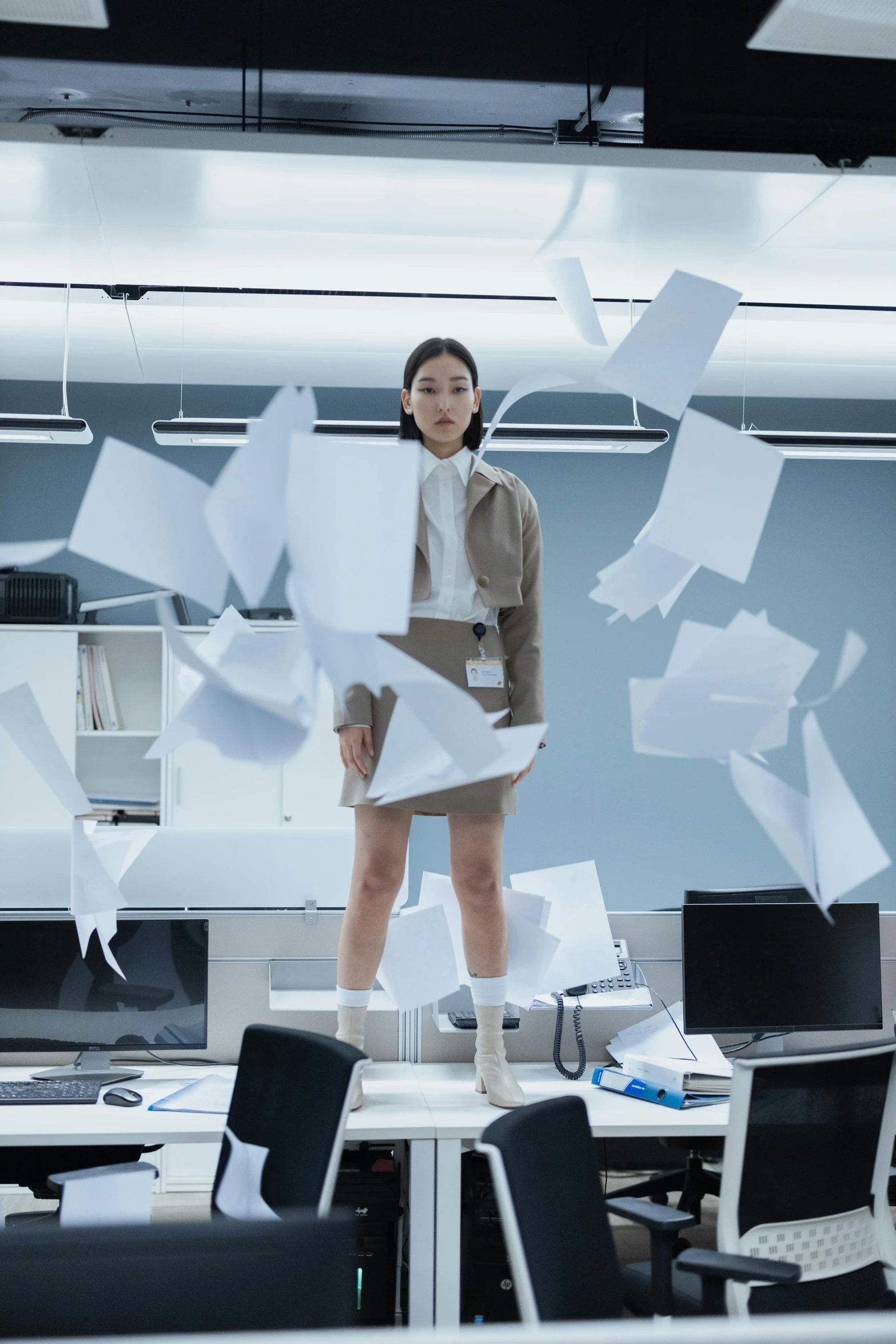 a woman standing in an office surrounded by papers, by Fei Danxu, unsplash, hyperrealism, epic scifi movie still, kiko mizuhara, flying debris, nvidia promotional image