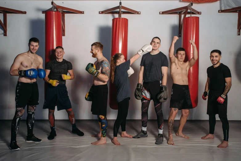 a group of men standing next to each other, by Emma Andijewska, pexels contest winner, kickboxing, panorama, 🦩🪐🐞👩🏻🦳, mid-transformation