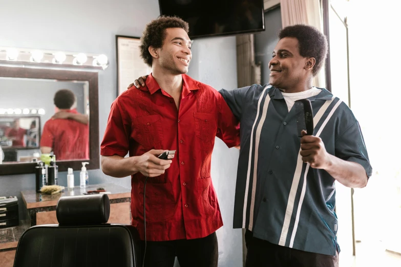 two men standing next to each other in a barber shop, by Everett Warner, pexels, red shirt brown pants, avatar image, afro comb, smiling at each other