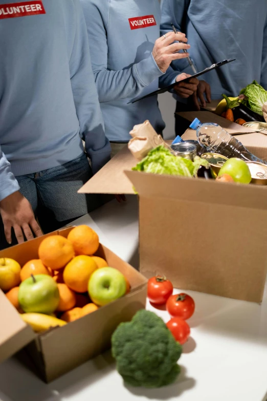 a group of people standing around a table filled with boxes of fruit and vegetables, closeup photograph, transforming, thumbnail, recipe