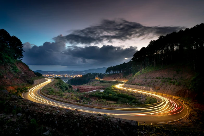 a long exposure photo of a winding road at night, by Nadir Afonso, te pae, offset photography, late morning, bright rim light