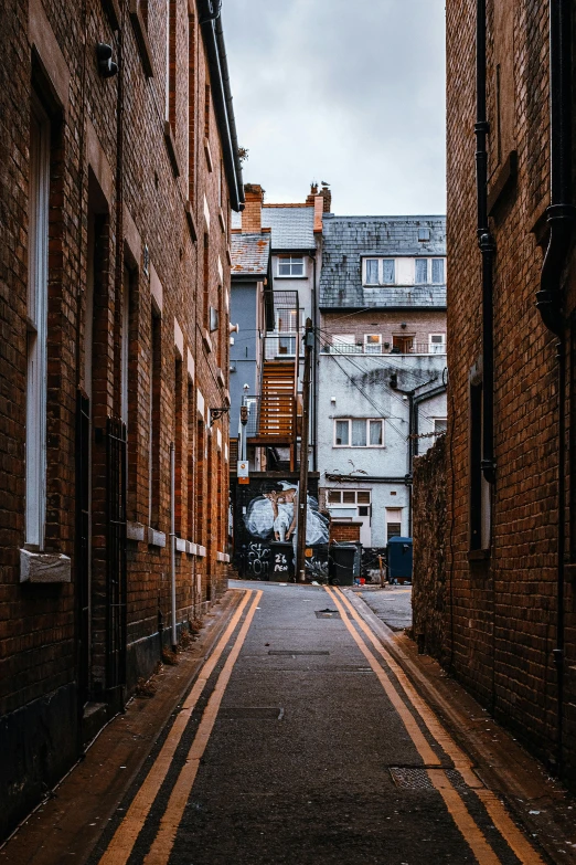 a narrow street lined with tall brick buildings, inspired by Thomas Struth, pexels contest winner, hull, staggered terraces, today\'s featured photograph 4k, alleys