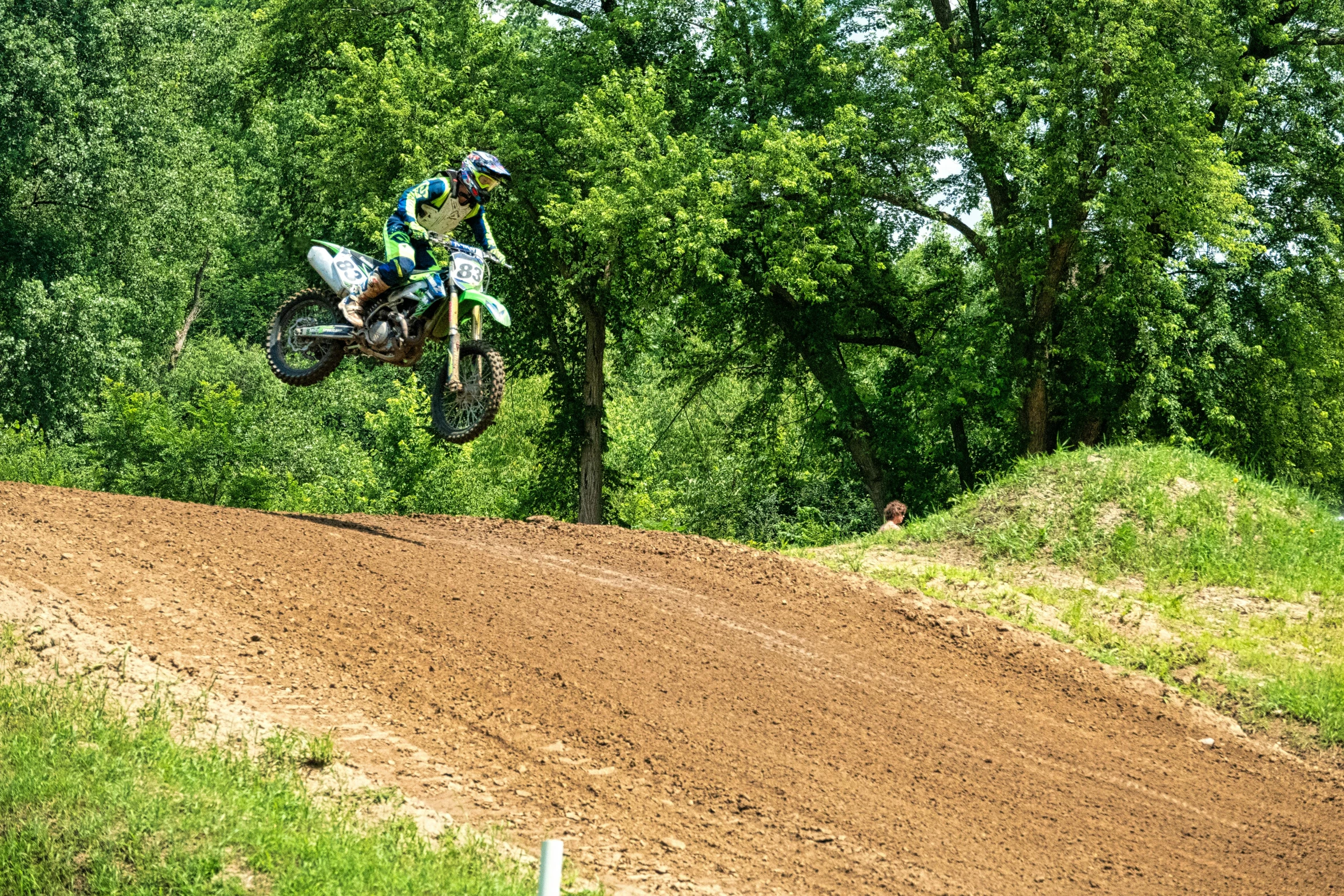 a man flying through the air while riding a dirt bike, inspired by Cam Sykes, green hill, avatar image, decoration, minn