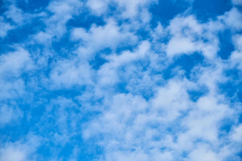 a large jetliner flying through a blue sky, an album cover, by Carey Morris, unsplash, minimalism, cotton clouds, blue, today\'s featured photograph 4k, cloud nebula