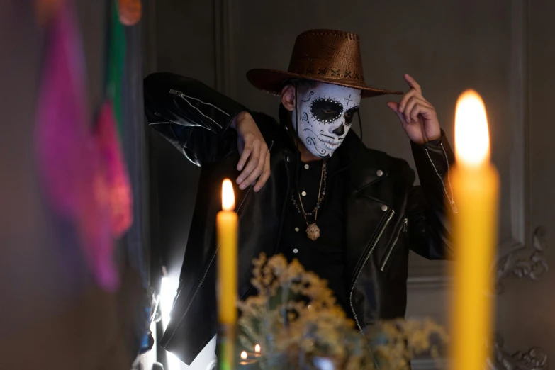 a man with a skeleton face painted on his face, an album cover, pexels contest winner, caracter with brown hat, leather robes, ( ( ( el dia los muertos ) ) ), vantablack