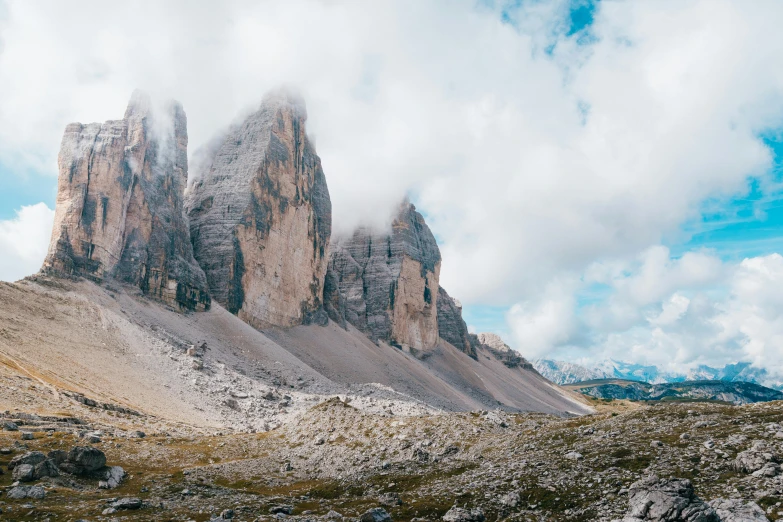 some very tall mountains with some clouds in the sky, pexels contest winner, in the dolomites, rocks coming out of the ground, panoramic, youtube thumbnail