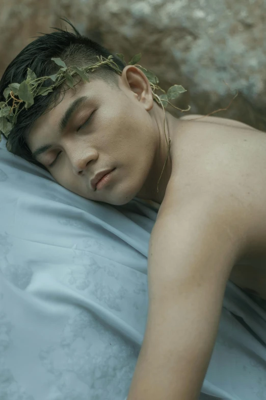 a man sleeping with a crown of leaves on his head, an album cover, inspired by Dai Jin, pexels contest winner, romanticism, an epic non - binary model, movie still, darren quach, video still