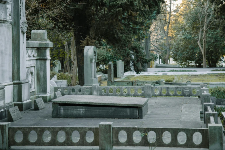 a couple of benches sitting next to each other in a cemetery, an album cover, unsplash, chile, ilya golitsyn, overview, historical image