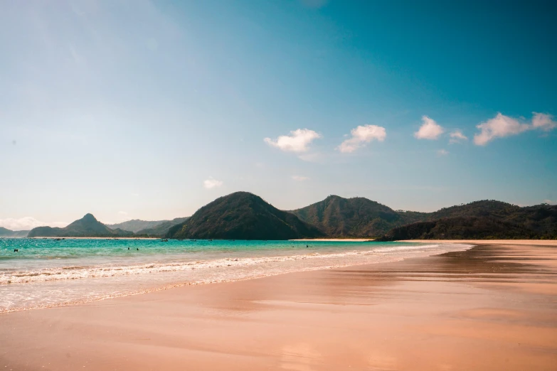 a sandy beach with mountains in the background, pexels contest winner, sumatraism, pink white turquoise, clear and sunny, 1 2 9 7, slide show
