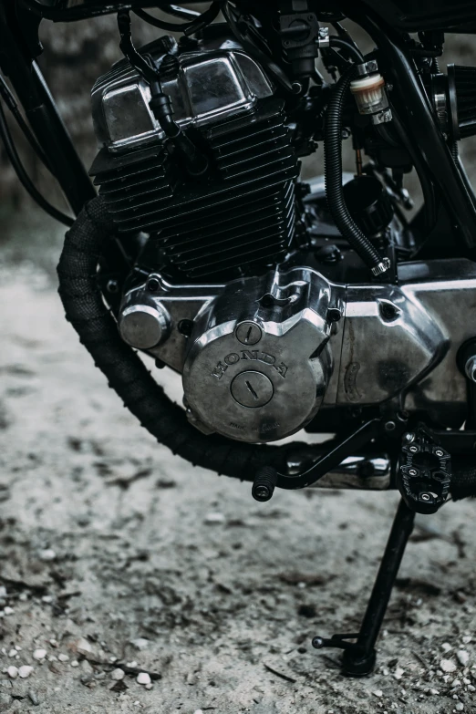 a motorcycle parked on the side of a dirt road, pexels contest winner, photorealism, closeup of car engine, liquid polished metal, profile close-up view, hindu