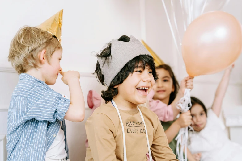 a group of children sitting on top of a bed, a cartoon, pexels contest winner, happening, party hats, head bent back in laughter, balloon, profile image