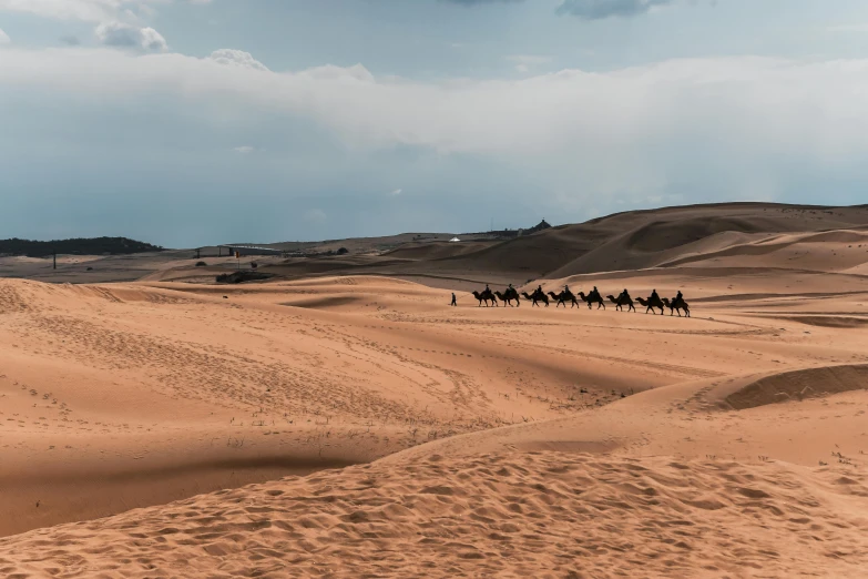a group of people riding camels across a desert, by Julia Pishtar, pexels contest winner, hurufiyya, victorian arcs of sand, thumbnail, distant photo, 🚿🗝📝