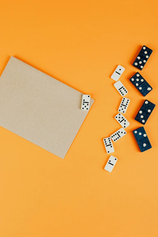 a laptop computer sitting on top of a desk next to dominos, pexels contest winner, conceptual art, in front of an orange background, paper cutouts of plain colors, game cover, polka dot