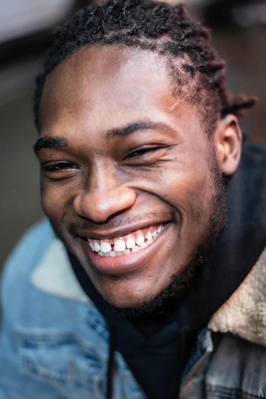 a man with dreadlocks smiles at the camera, trending on pexels, grime, smiling laughing, kai carpenter, lil uzi vert