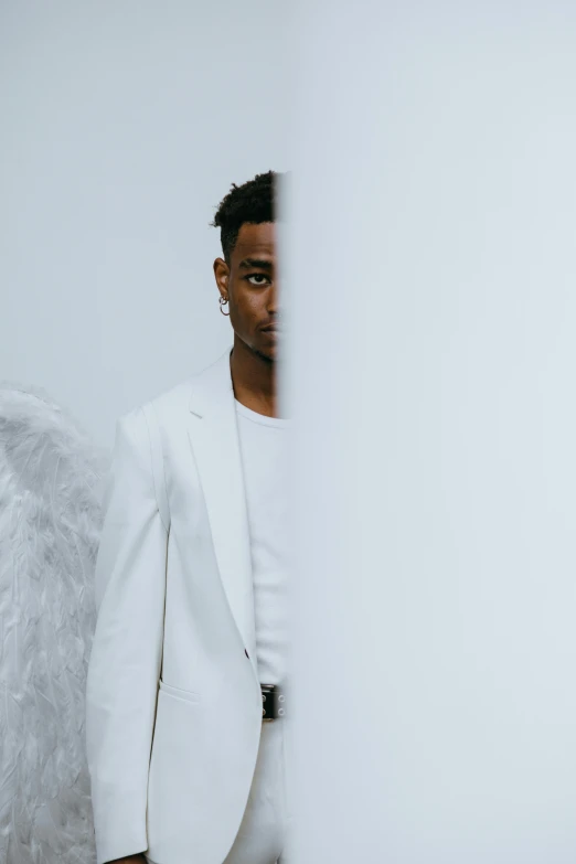 a man in a white suit and angel wings, an album cover, inspired by Xanthus Russell Smith, white backdrop, syd, wide angel shot, ignant