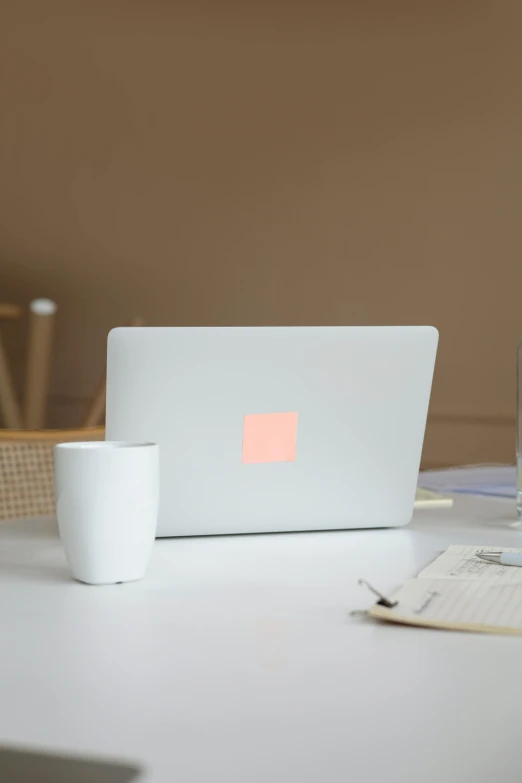 a laptop computer sitting on top of a white table, by Daniel Seghers, square, pink light, white mug, full image