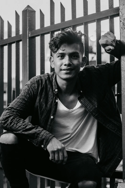 a black and white photo of a man on a skateboard, a black and white photo, pexels contest winner, sumatraism, androgynous face, standing astride a gate, dimples, indonesia