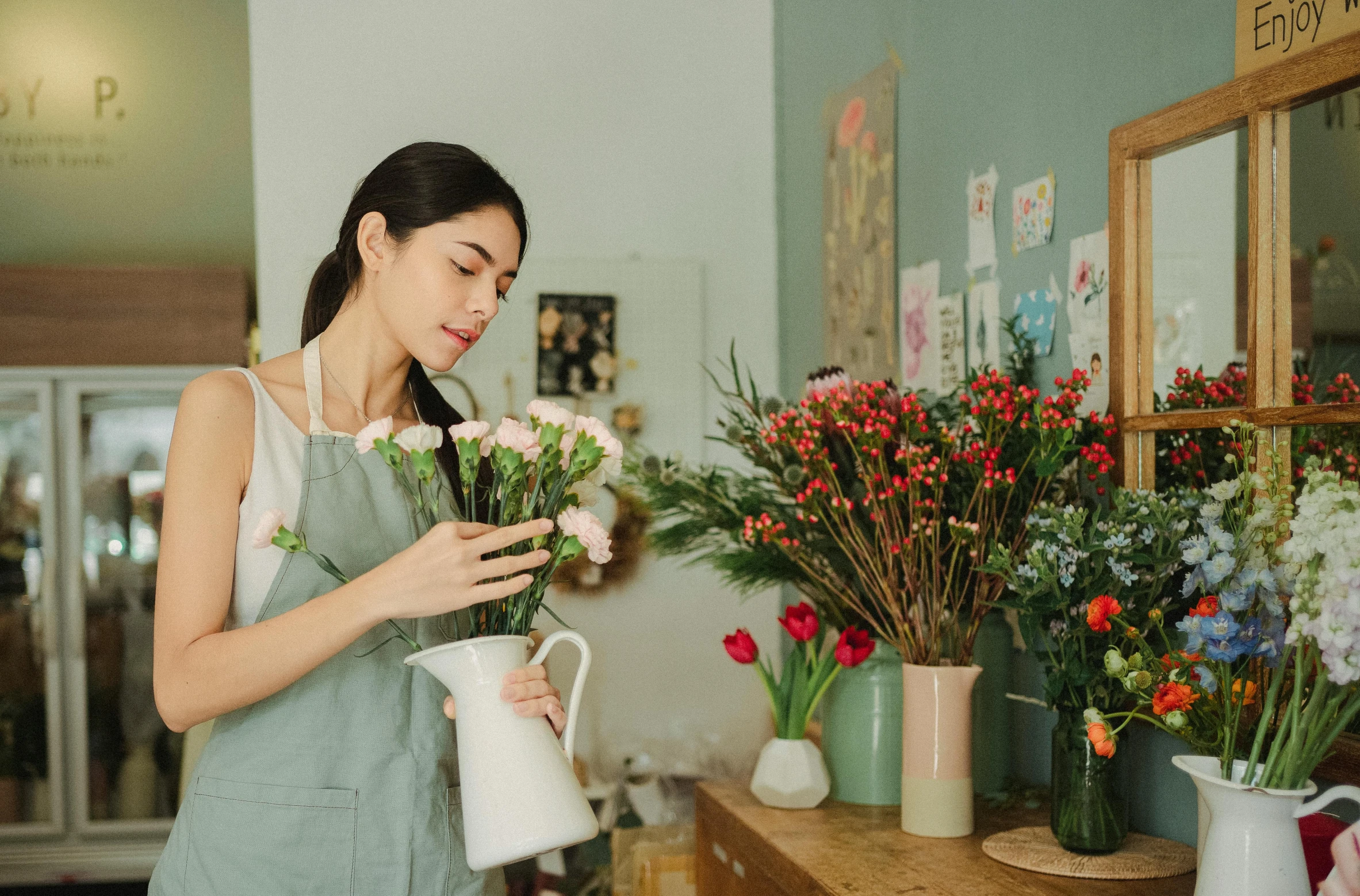 a woman standing in front of a bunch of flowers, neat and tidy, on a canva, vase work, maintenance