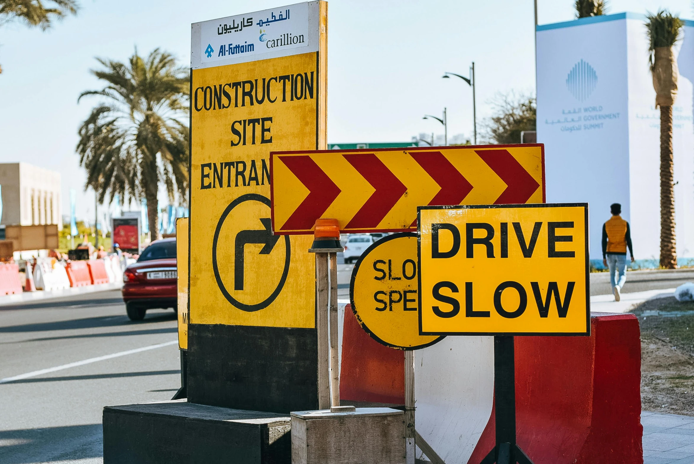 a couple of signs sitting on the side of a road, pexels, constructivism, dubai, heavy traffic, reconstruction, thumbnail