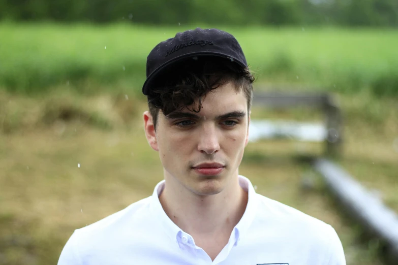 a close up of a person wearing a hat, liam brazier, baseball cap, a handsome man，black short hair, on a farm