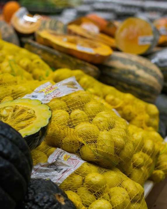 a display in a grocery store filled with fruits and vegetables, unsplash, renaissance, yellow and olive color scheme, thumbnail, brazilian, pumpkins