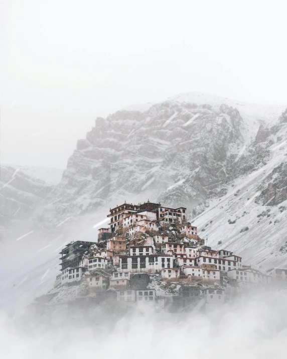 a large building sitting on top of a snow covered mountain, inspired by Steve McCurry, pexels contest winner, renaissance, hindu aesthetic, foggy day, the village on the cliff, festivals