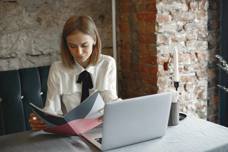 a woman sitting at a table with a laptop, trending on pexels, private press, wearing a white blouse, avatar image, high quality paper, post graduate