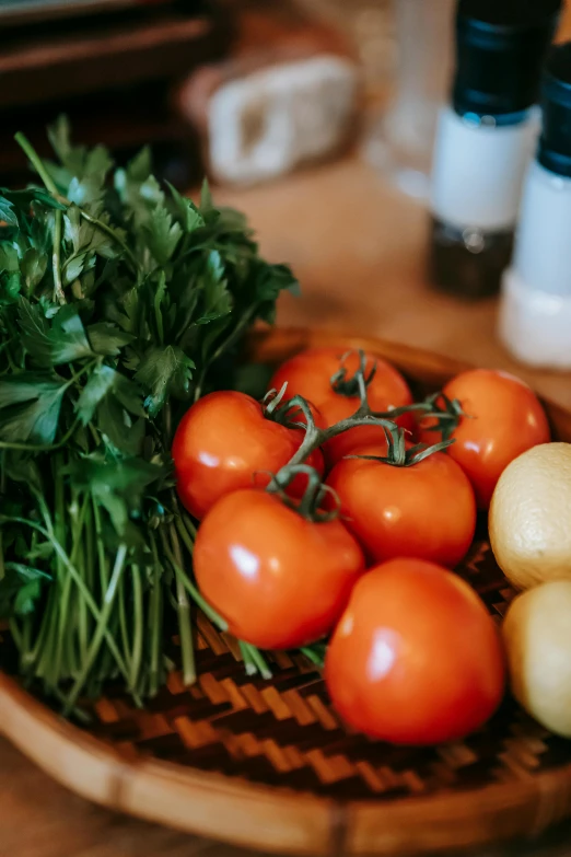 a wooden bowl filled with vegetables on top of a table, by Matt Cavotta, pexels, tomatoes, in a kitchen, greens, headshot