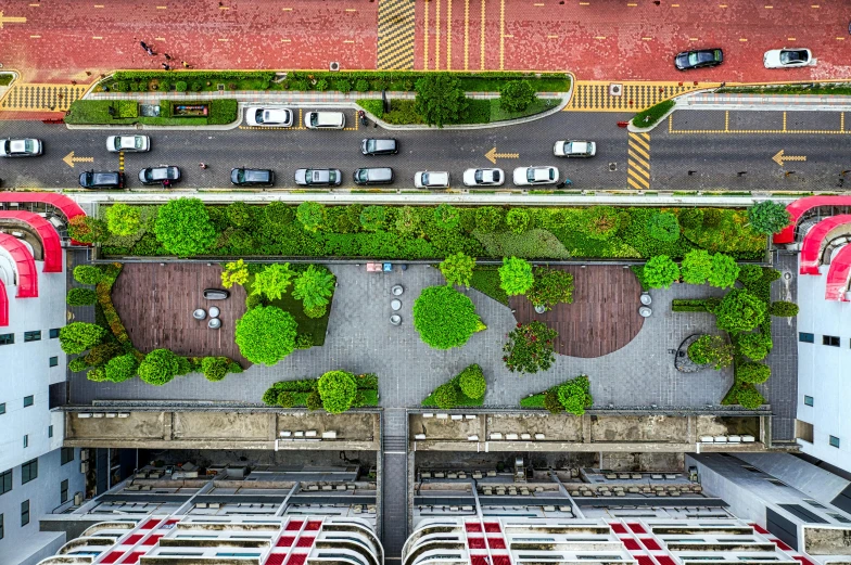 an aerial view of a parking lot with cars, pexels contest winner, hanging gardens, shanghai city, green and red plants, streetscape