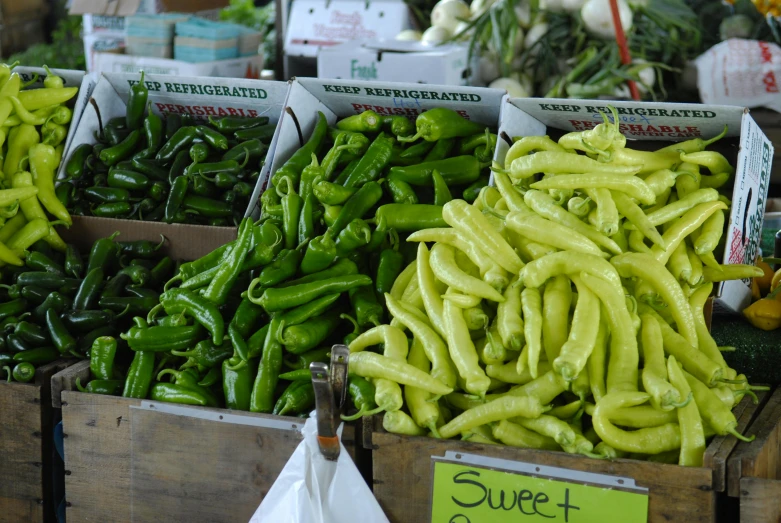 a wooden box filled with lots of green peppers, by Meredith Dillman, pexels, farmer's market setting, painted pale yellow and green, green neon signs, a super-smart