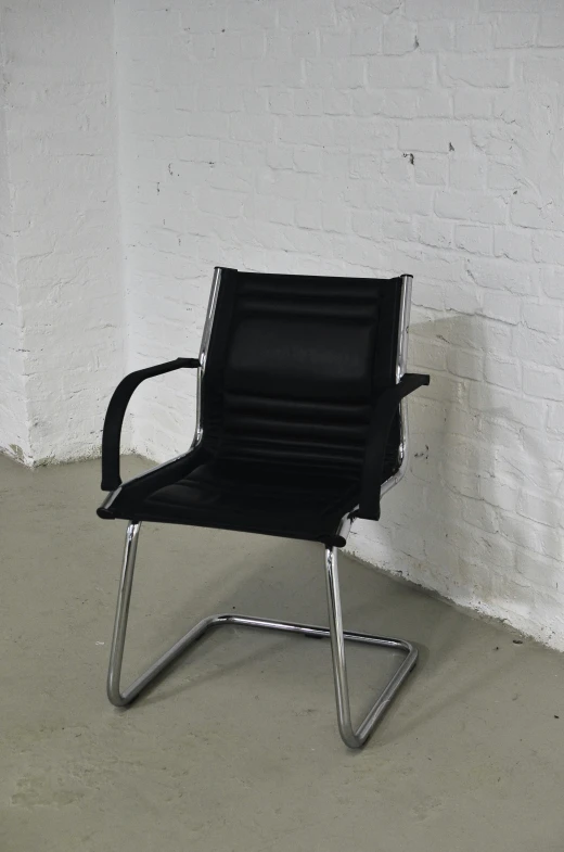 a black office chair against a white brick wall, reddit, 2 5 6 x 2 5 6 pixels, morhbacher, product view, lambda