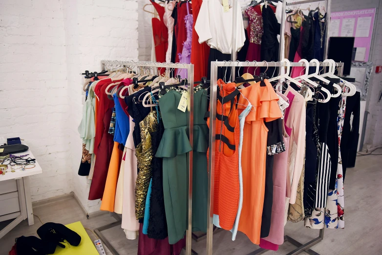 a rack of clothes in a clothing store, a photo, maximalism, sofya emelenko, neon colored dress, private collection, thumbnail