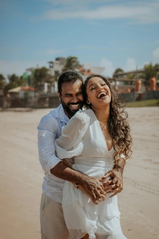 a man and woman hugging on the beach, pexels contest winner, happening, both smiling for the camera, brazil, laughing groom, icon