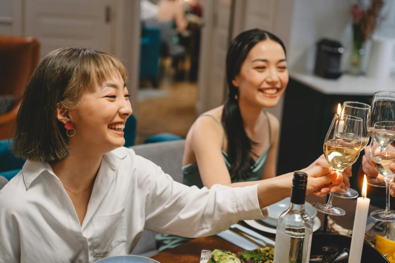 a group of people sitting at a table with wine glasses, a picture, avatar image, asian female, two girls, exciting