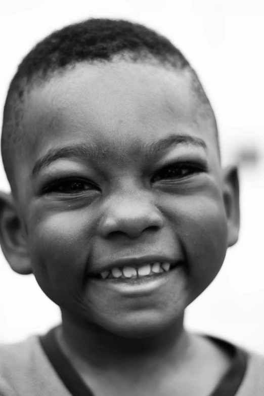a black and white photo of a young boy, by Joze Ciuha, detailed smile, actual photo, 5 years old, baleful young