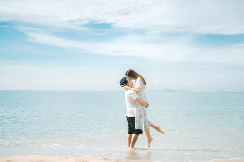 a man standing next to a woman on top of a beach, by Arabella Rankin, pexels contest winner, romanticism, asian man, lovely kiss, plain background, thumbnail