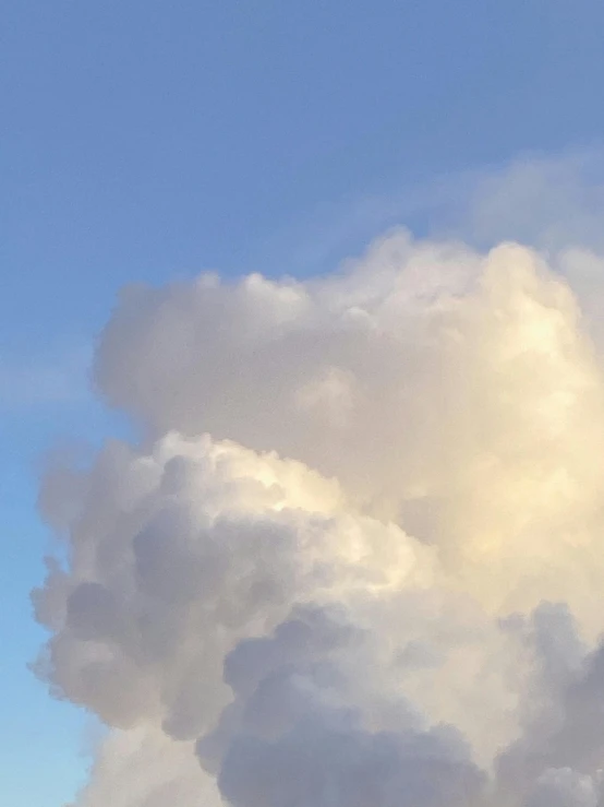 a jetliner flying through a cloudy blue sky, an album cover, unsplash, aestheticism, ☁🌪🌙👩🏾, cotton candy clouds, profile image, close-up photograph