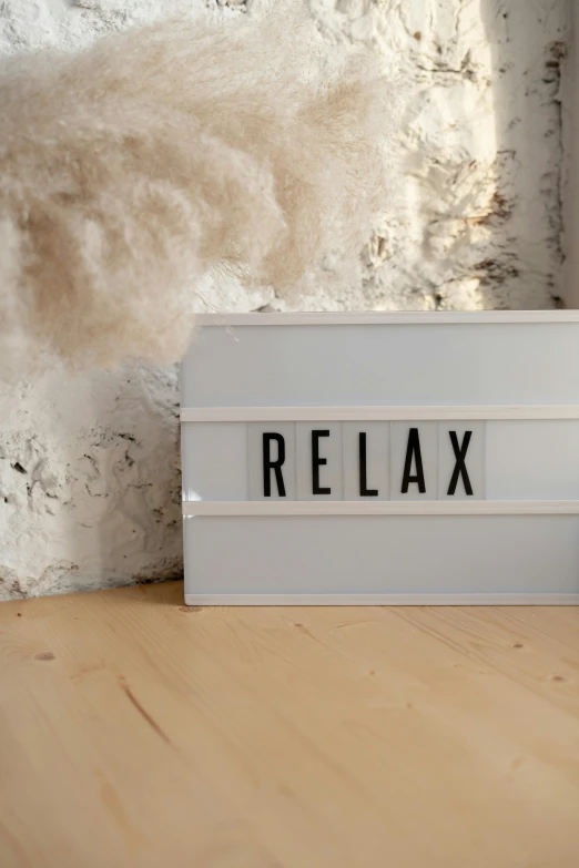 a white light box sitting on top of a wooden table, by Arabella Rankin, trending on unsplash, graffiti, relax, striped, subtitles, close-up product photo