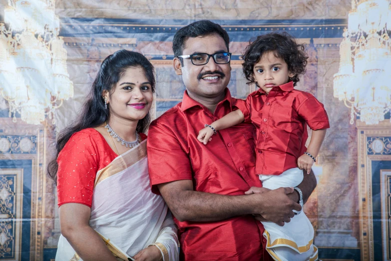 a man and woman holding a small child, a portrait, pexels contest winner, hurufiyya, avatar image, vinayak, portrait image, high resolution photo